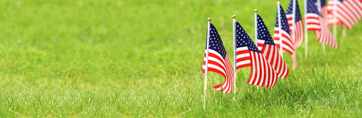 American flags on grass. Independence Day concept. USA holiday.