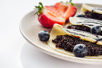 sweet dessert pancakes with quinoa on a white background