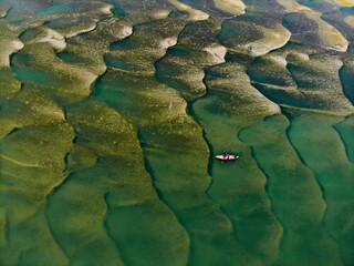 Huge sandbars arise in river Jamuna when the water level drops during the dry season. The striking pattern and textures look like desert when seen from above. Aerial sandbar view. Beauty of Nature.