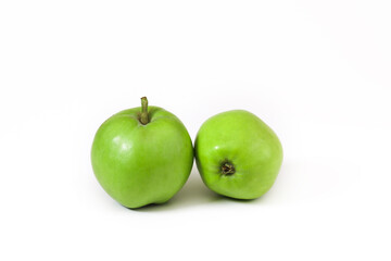 Small green apples on a white background. Close-up