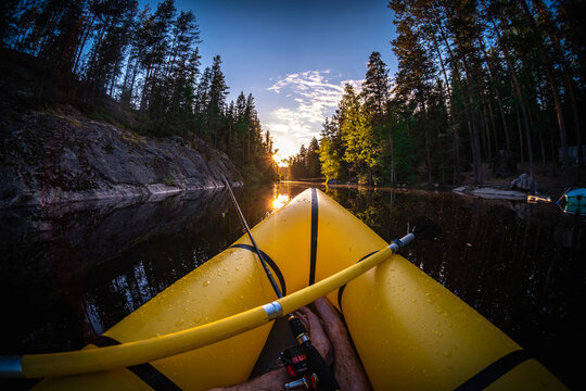 Fisherman in a yellow boat on the river