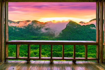 Looking out from the wooden balcony, a beautiful view of Landscape during a colorful sunrise on top