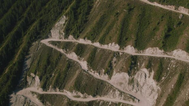 Danger Katu Yaryk Pass with traffic cars in Chulyshman valley in Altai, Siberia, Russia. Beautiful summer nature landscape at during daytime. Aerial view from a drone