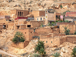 Stairstepped homes made from clay and stone  in Berber village in Atlas Mountains of Morocco.