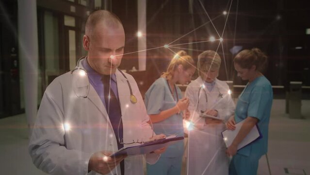 Animation of connections over caucasian male doctor with notes