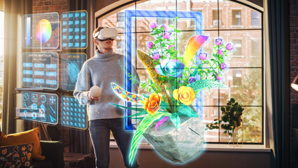 Fototapeta premium Young Beatiful Women is Using Virtual Reality Headset for Design Project In Stylish Loft Apartment. Casualy Dressed Female is Using Innovative Softwear to Work. 3D Flowers Concept.