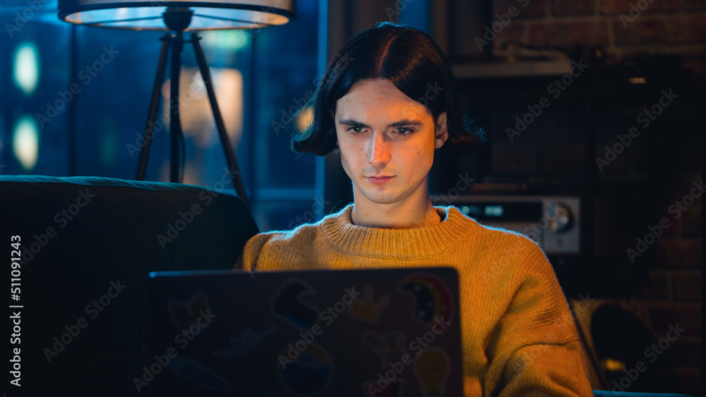 Poster close up portrait of a handsome man working from home on laptop computer in stylish loft apartment i