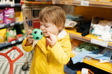 child in the market buys a small ball