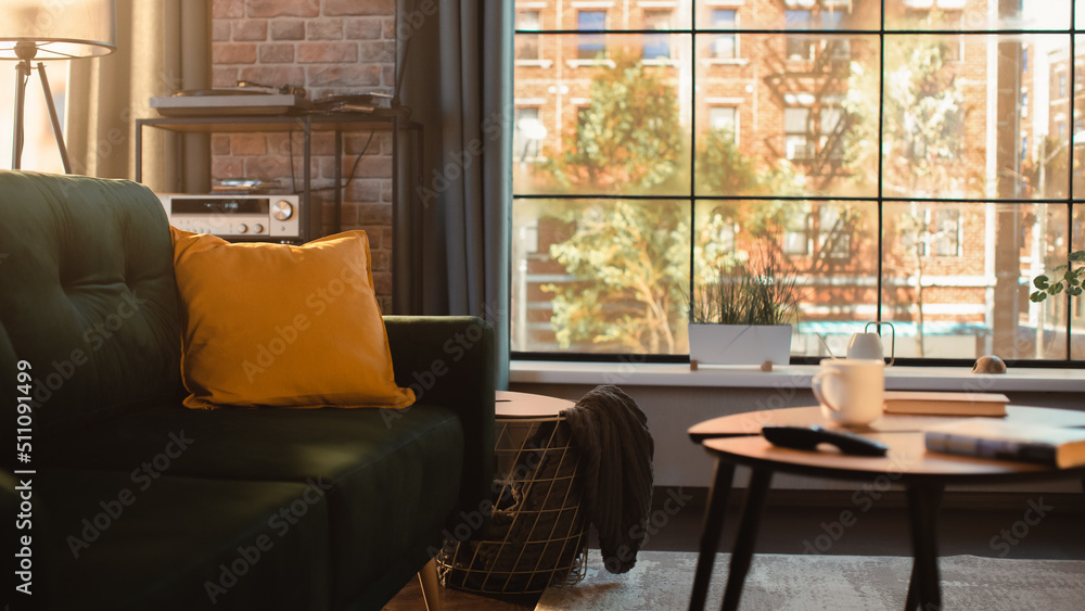 Poster empty living room in stylish loft appartment. modern flat is furnished with designer sofa and coffe 