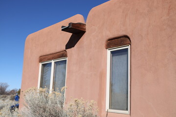 pueblo style home exterior with windows