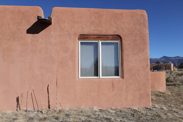 pueblo style home exterior with windows