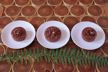 there are three servings of chocolate cake on the table. dessert.