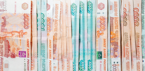 horizontal background of spread out paper money in denominations of one thousand and five thousand Russian rubles - obrazy, fototapety, plakaty
