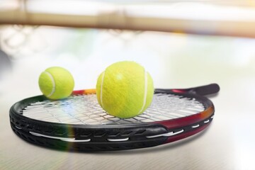 Black professional tennis racket and ball on background. Sport theme poster