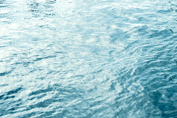 Water surface with ripples and sunlight reflections