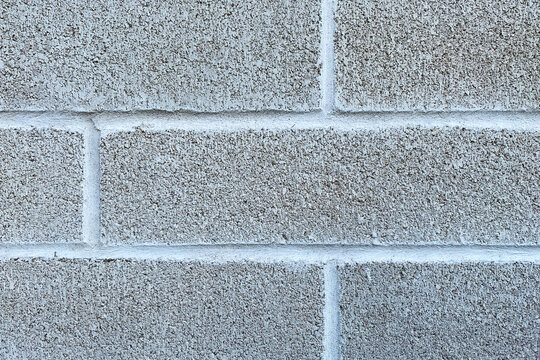 white cinder blocks closeup solid block brick wall cement exterior building facade design copy space