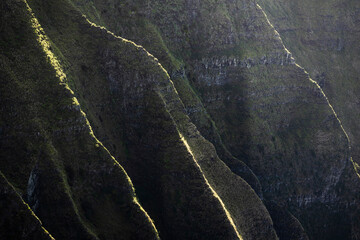 Light hits the steep ridges of Kauai's Na Pali Coastline