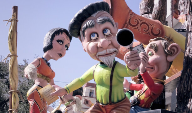 PUTIGNANO, ITALY - FEBRUARY 3, 2013: a big paper mache character shaped as a grandfather, mounted on a chariot from the traditional Carnival float parade. This is one of the oldest and longest (dated 