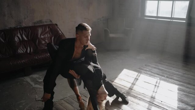 Couple of two dancers modern dance is dancing on loft studio with big window. Beautiful art performance. Passion and emotional dance.