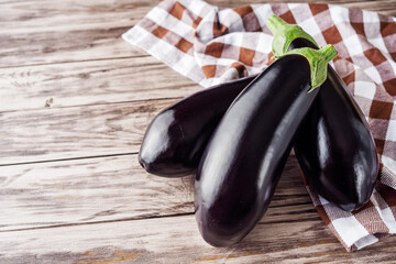 fresh natural eggplant on a light white wooden rustic background