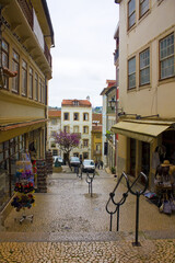 Picturesque street with ancient houses in Old Upper Town of Coimbra, Portugal	
