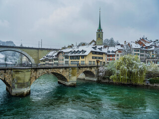 Fototapeta na wymiar Nydeggbrucke and untertorbrucke bridge and swiss buildings on Aare in Bern, Switzerland