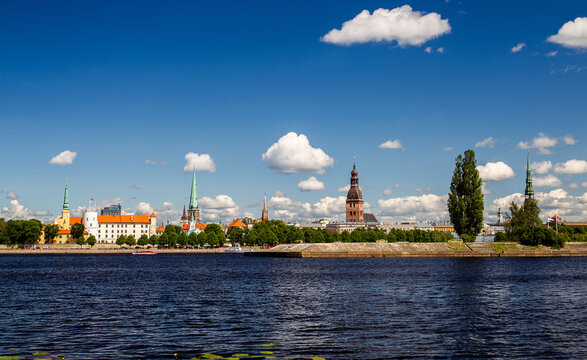 Famous panorama of Riga with St. Peter's Church and Riga Cathedral  anther  side of Daugava rive- fantastic  architecture of  Middle Ages  Latvian  capital, picturesque,
