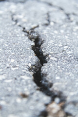 Stone wall with deep cracks. Break in the ground. Drought and consequences.