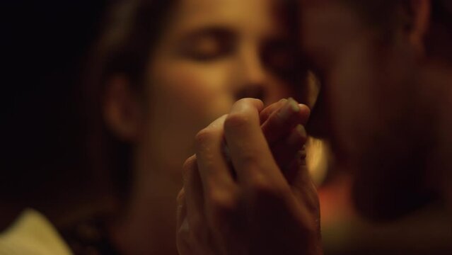 Intimate man hands hold woman on romantic date closeup. Couple love concept.