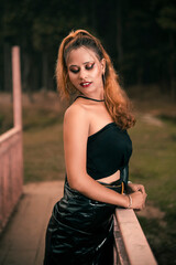 Portrait of Beautiful Model outdoor. close up portrait of young model standing in wooden Bridge. 