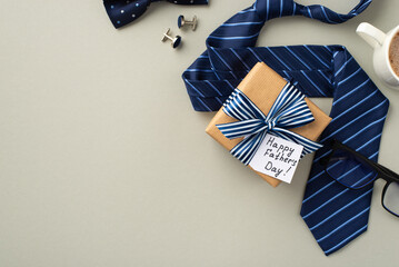Father's Day concept. Top view photo of craft paper gift box with striped ribbon bow and postcard...