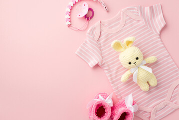 Baby accessories concept. Top view photo of pink infant clothes bodysuit booties pacifier chain and...