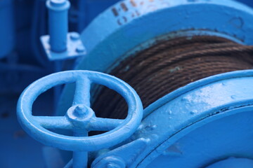 The mooring deck of a cargo ship with anchor winches, an anchor chain on winches, ship mechanisms.
