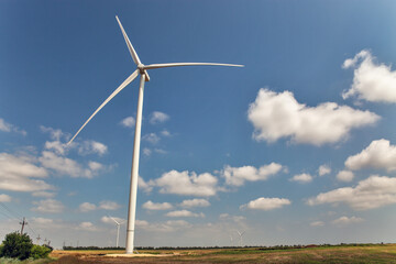 Fototapeta premium Wind farm with high wind turbines for generation electricity