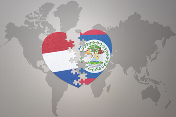 puzzle heart with the national flag of belize and netherlands on a world map background.Concept.