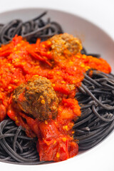 black spaghetti with tomato sauce with meat balls