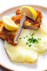 chicken schnitzel with mashed potatoes and lemon