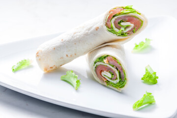 tortilla filled with smoked salmon and lettuce