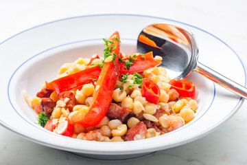 mixture of yellow peas and bacon served with red pepper and chilli