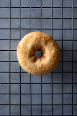 A top down view of a plain cake donut.