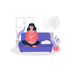 A pregnant woman is sitting on the couch. The girl holds her stomach with her hands. A cat is lying nearby.