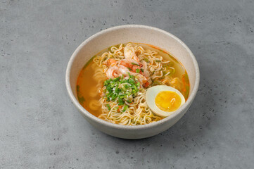 asian instant noodle with shrimps on gray background