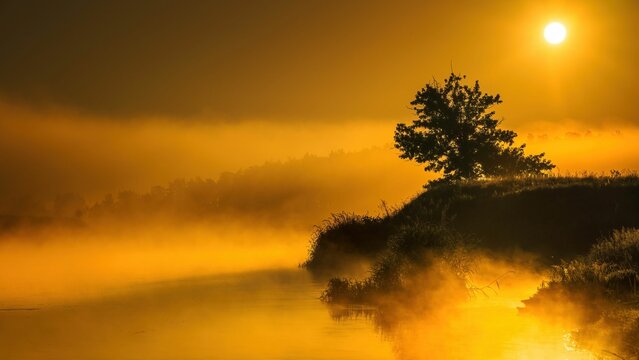 Fototapeta Wschód słońca nad rzeką Wartą. Słońce, mgła i rzeka o świcie