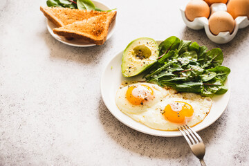 Healthy Breakfast with Wholemeal Bread Toast, Eggs with Green Salad, Avocado. traditional breakfast