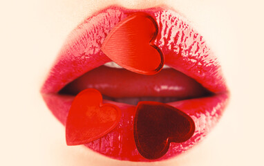 Valentines Day. Beautiful love, mak-eup. Red heart on lips, Valentines Day. Valentine lip. Gloss red heart lip. Valentine heart, kiss on the lips. Makeup, beauty sexy lips with heart