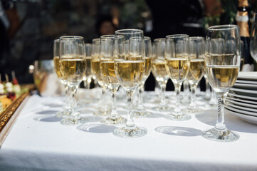 Glasses of champagne at the Banquet, white sparkling wine in wine glasses, festive mood