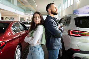 a young married couple cannot find mutual understanding when buying a new car in a car dealership