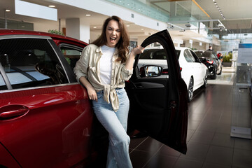 satisfied young woman after she was approved for a loan to buy a new car