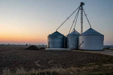 Silos in a field at sunrise
