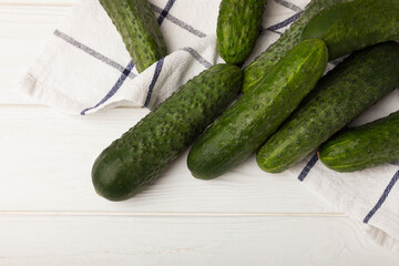 Fresh cucumbers on white texture wood. Vegetarian organic vegetables.Ingredient for salad. Healthy food.Copy space.Place for text
